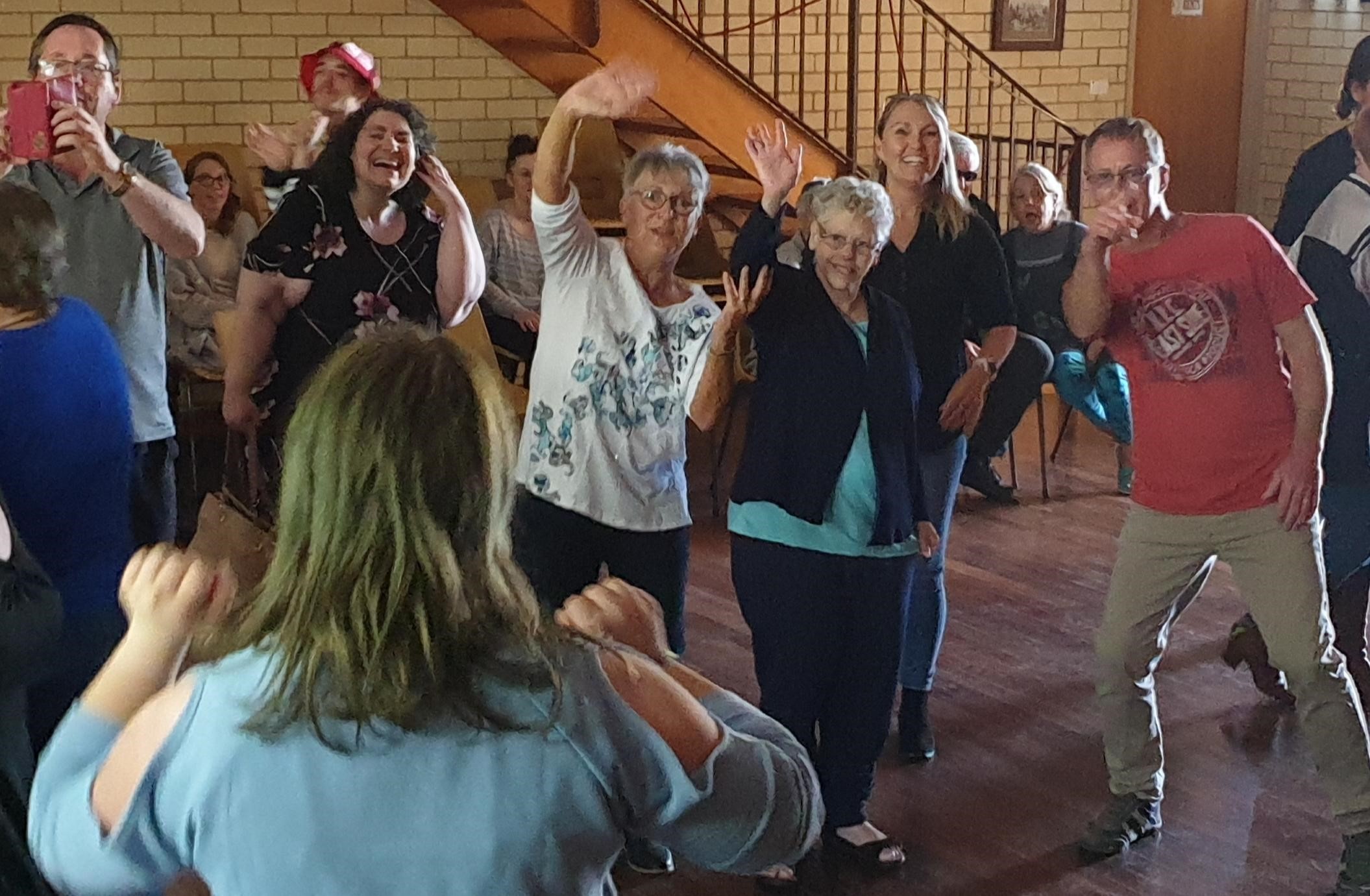 People with disability, support workers and friends dancing at Rock the Coast in Middleton.